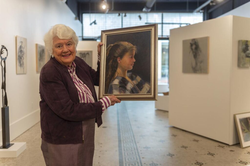 Senior woman holding a photo from Craig Hudson