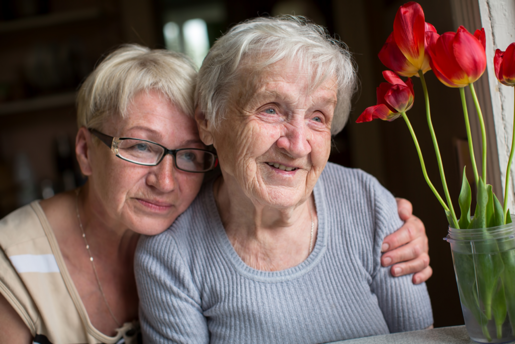 Caregiver and her senior mother taking a picture together