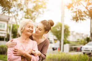 Elderly woman and caregiver daughter