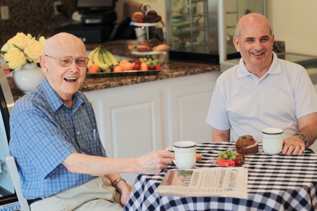 Two Residents Eating breakfeast and drinking coffee