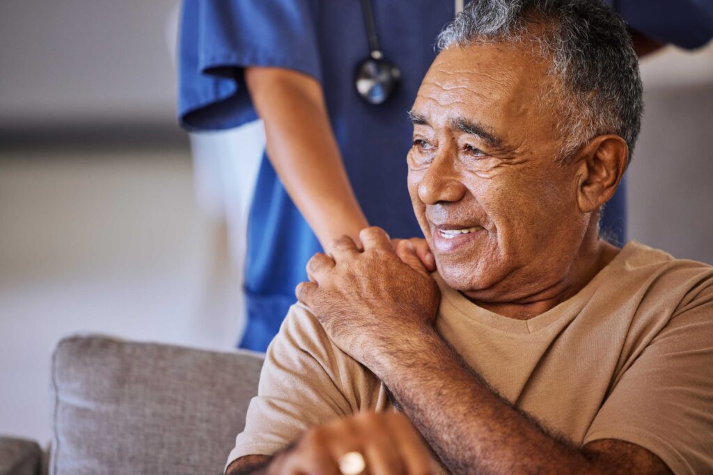 Caregiver with hand on shoulder of resident